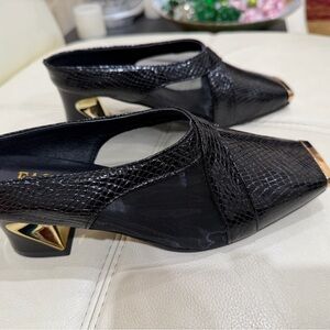 Elegant Black and Gold Women's Shoes with black net on the sides.